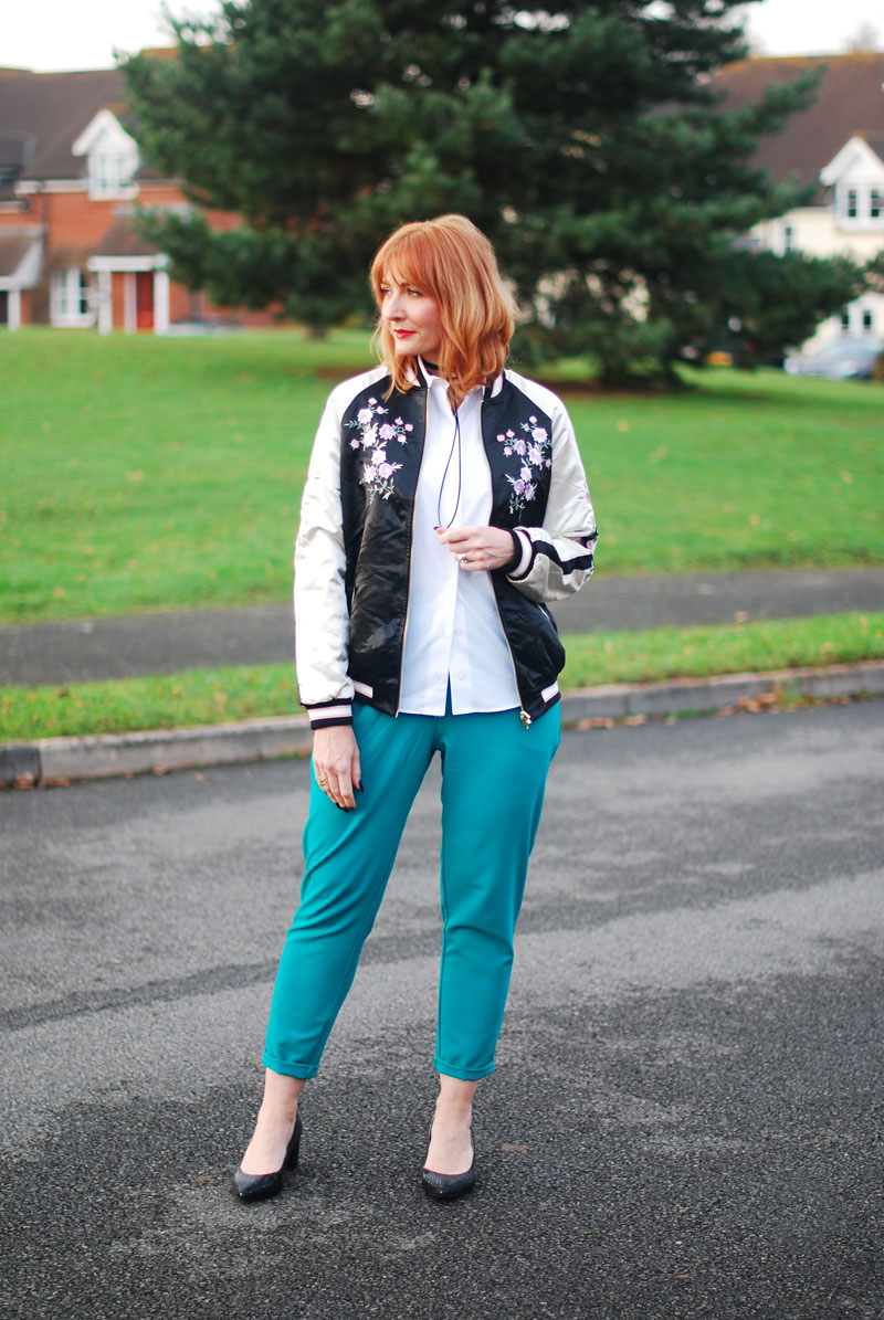 Smart casual weekend wear floral embroidered bomber jacket emerald green peg leg trousers black block heel shoes white shirt black tie-up choker necklace | Not Dressed As Lamb, over 40 style