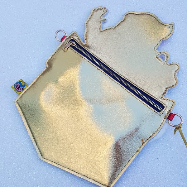 back of chimney shaped clutch bag in gold metallic