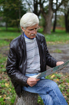 Old man reading newspaper