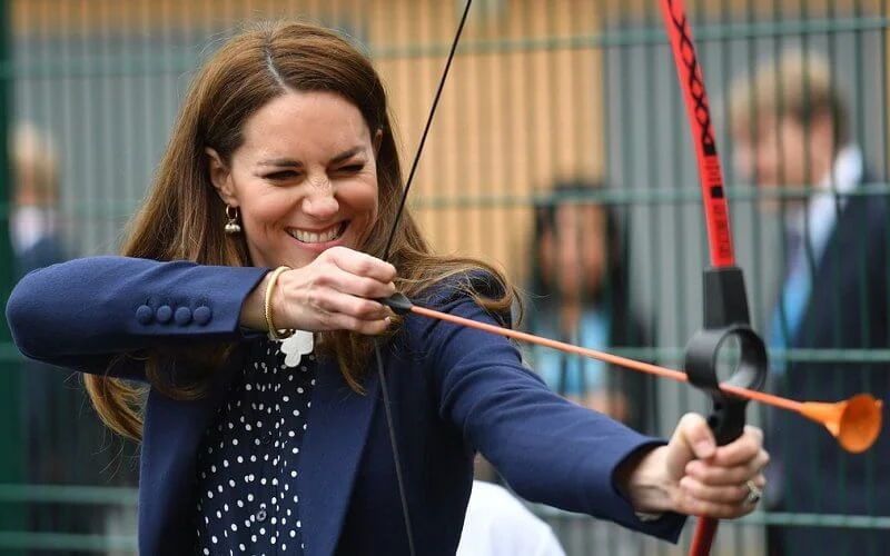 Kate Middleton wore a new polka dot blouse from Tory Burch, and high waisted trousers from Jigsaw. Freya Rose gold hoops with pearls