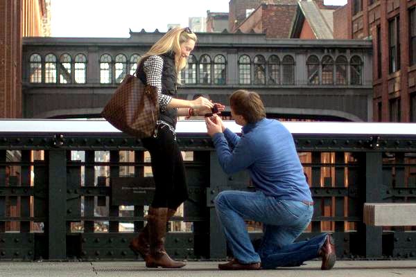 屋外のカップル。男性は片膝で、指輪を指し出し、女性にプロポーズをしている。