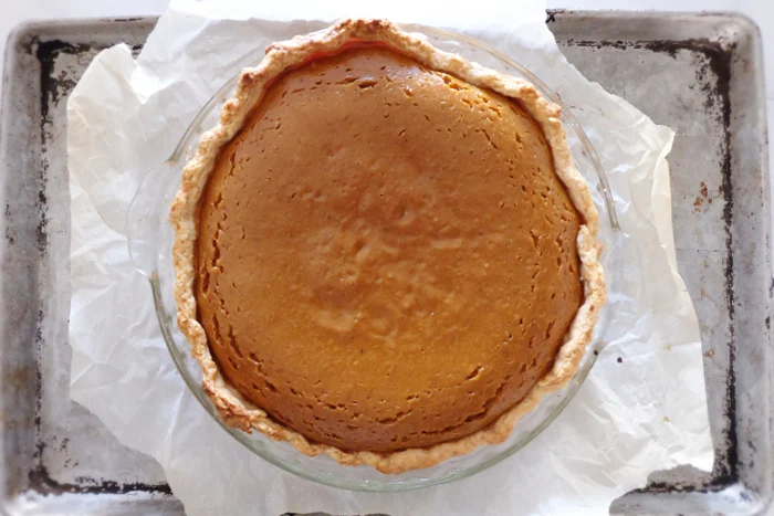 baked pumpkin pie on baking sheet