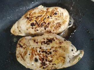 Chicken breasts grilled on pan for healthy chicken parmesan recipe