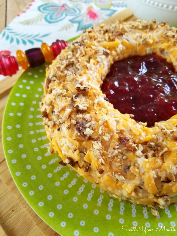 Pecan Cheddar Cheese Ring with Strawberry Preserves | Rosalynn Carter’s vintage appetizer recipe for a pecan and cheddar cheese ring with a slight hint of heat with strawberry preserves in the center served with crackers.