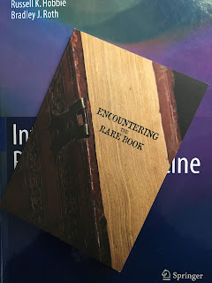 Ecountering the Rare Book, an exhibition celebrating the Special Collections in Kresge Library at Oakland University, organized by Andrea Eis. Ecountering the Rare Book, an exhibition celebrating the Special Collections in Kresge Library at Oakland University, organized by Andrea Eis, superimposed on Intermediate Physics for Medicine and Biology.