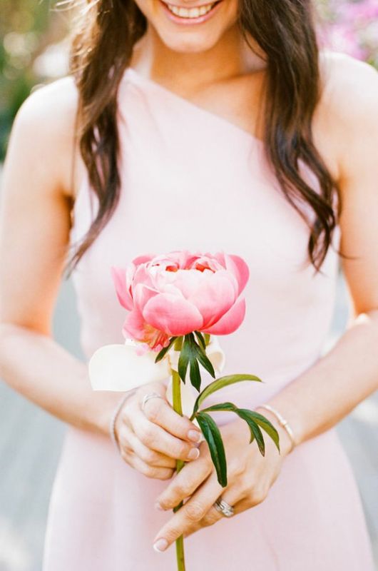 Instead of a bouquet, bridesmaids can carry a single statement flower.