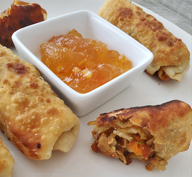 these are a homemade fried egg roll with an orange pineapple dipping sauce