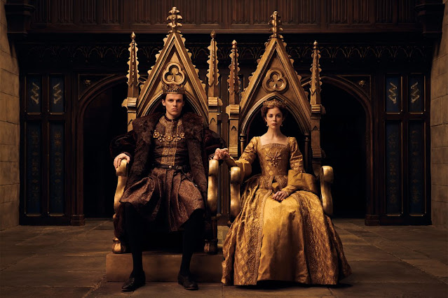 King Henry VIII and Queen Catherine of Aragon sitting in their thrones hand-in-hand from The Spanish Princess