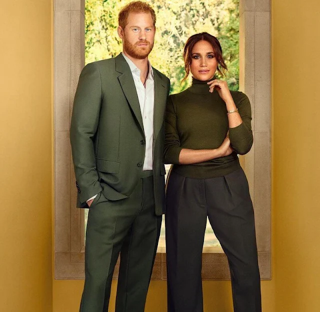 Meghan Markle wore pleated wool wide leg trousers by Victoria Beckham, Armani. Duet Pinky Ring. Row Demme cashmere sweater