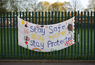 A Covid inspired 'stay safe' poster hangs on the fence of St Lawrences Primary School