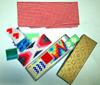 Box of small needlework samples