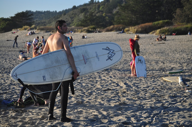 topless man male surfing beach california