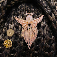 metallic paper quilled angel pin on knitted scarf