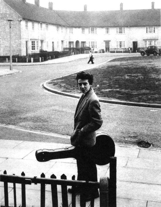 How did Harrison learn to play the guitar?