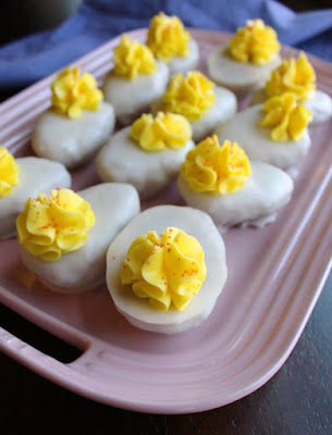 Deviled eggs have never been so sweet! These cute cake balls are perfect for Easter, BBQs, April Fools Day and more! serving tray with deviled egg cake balls