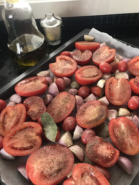 Photograph of tomatoes and eschallots ready for roasting in the oven