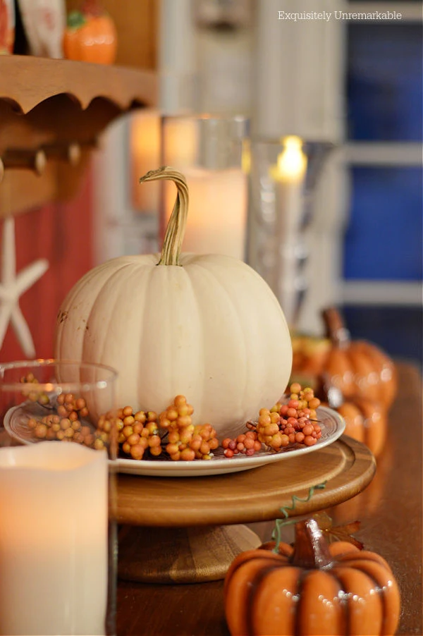 Fall Pumpkin Centerpiece and candles on a kitchen server