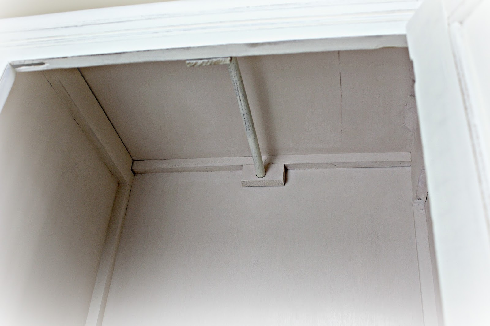 Wooden rod in wardrobe section of chifferobe. Wooden rod in wardrobe section of chifferobe.