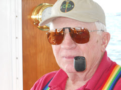 Happy man! A pipe to smoke, and new shades, cut to fit his glasses at the Boat Show