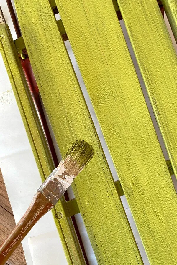 Painting The A Sled Green With A Brush