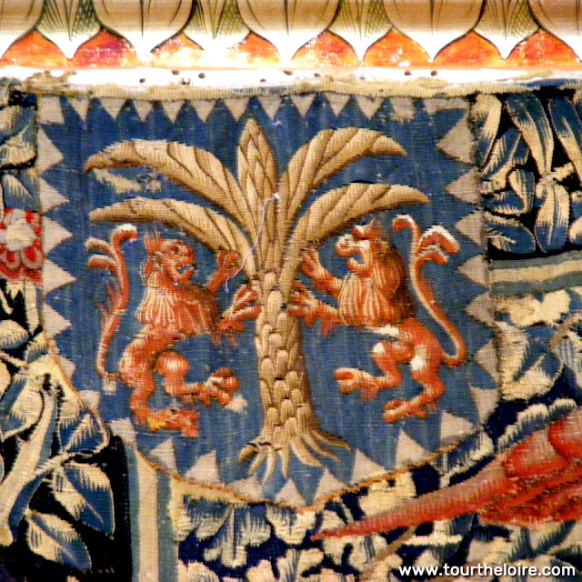 Patch depicting a coat of arms applied to one of the Life at the Chateau series of tapestries. Chateau de Chenonceau. Indre et Loire. France. Photo by Loire Valley Time Travel.