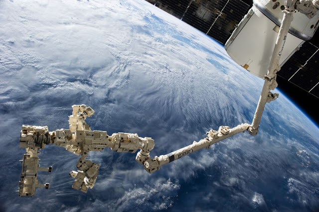 Backdropped against the blue and white Earth, and sporting a readily visible new addition in the form of the Canadarm2. The ISS was photographed following separation from the space shuttle Endeavour. (image: NASA Marshall Space Flight Center)
