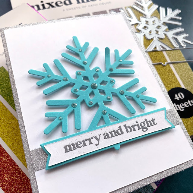 Snowflake Christmas cards made with: Scrapbook.com snowflake die, raninbow and mixed metals glitter paper, A2 smooth cardstock cools and jewels; pops of color silver glitter