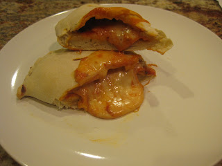 homemade calzone cut in half showing cheese and sauce inside