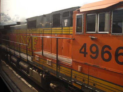 Bright orange BNSF engine with yellow stripes