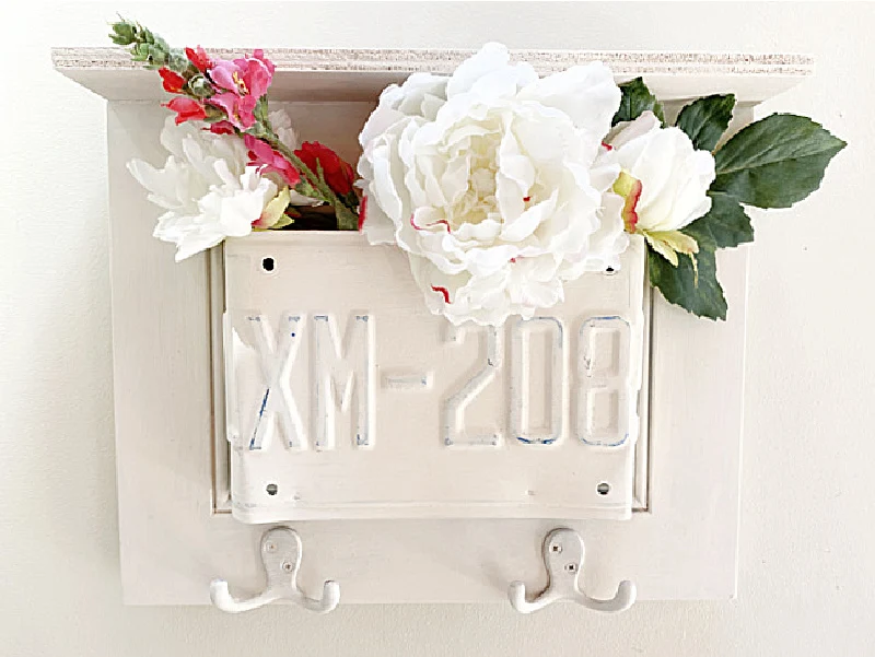 license plate shelf with flowers and hooks
