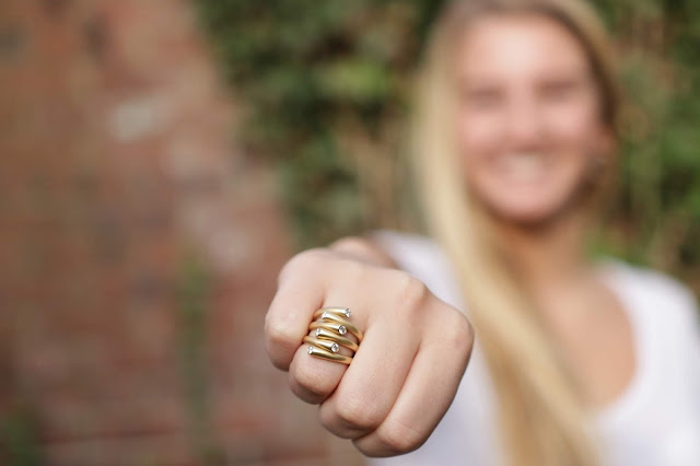 Gold Statement Ring Close up of woman wearing gold statement ring.