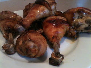 Asian chicken legs served on a white plate.