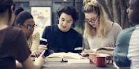 5 students at table with books