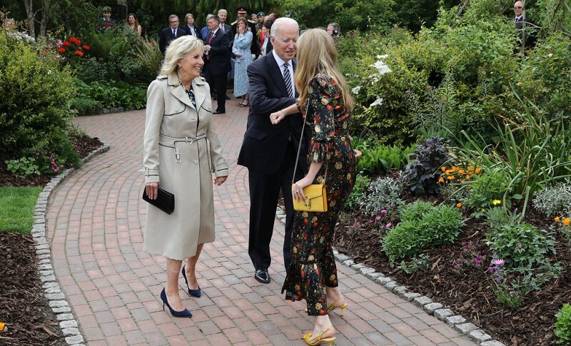 Queen in a floral outfit, Kate  in white coat dress, Carrie Johnson, wore a dressby Vampire’s Wife, Jill Biden in trench coat