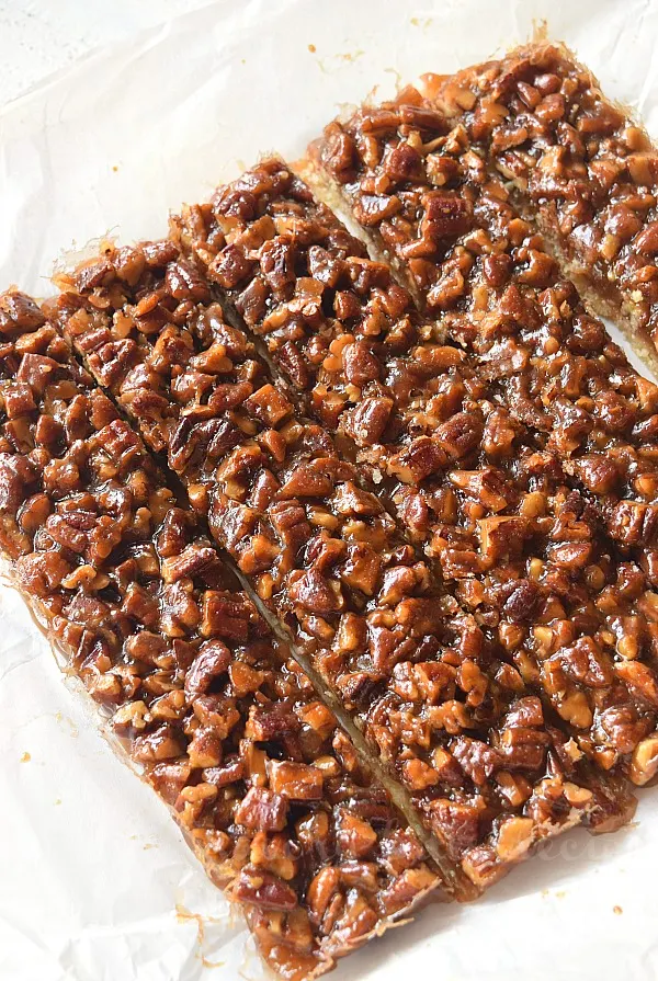 easy pecan pie bars on a parchment paper