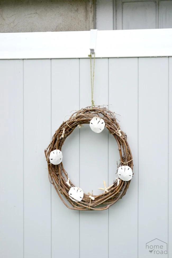 An over the door wreath hanger holding a wreath