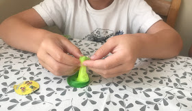 popping open pop pop snotz toy green slime and small toy