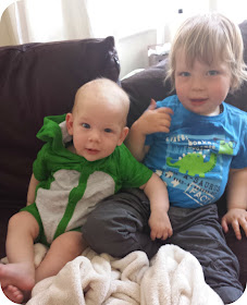 brothers, baby and toddler on sofa