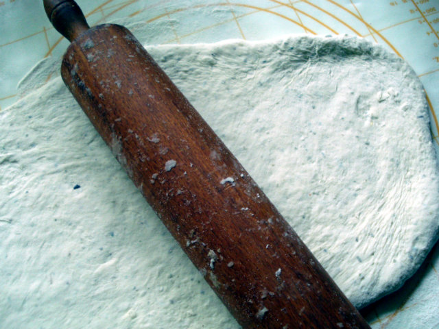 flatened dough with rolling pin