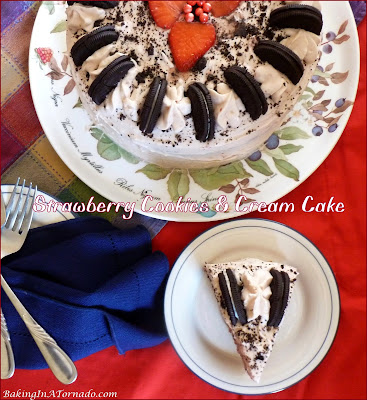 Strawberry Cookies and Cream Cake is studded with crushed cookies and chopped strawberries, then topped with a strawberry cream frosting and sprinkled with more crushed cookies. | Recipe developed by www.BakingInATornado.com | #recipe #dessert