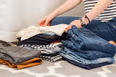 woman folding clothes for home move