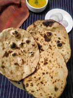 Serving 3 pieces of tandoori roti with dal and onion slices