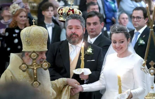 The bride Victoria Romanovna Bettarini wore a white satin gown by fashion designer Reem Acra, and the Lacis Tiara by Chaumet