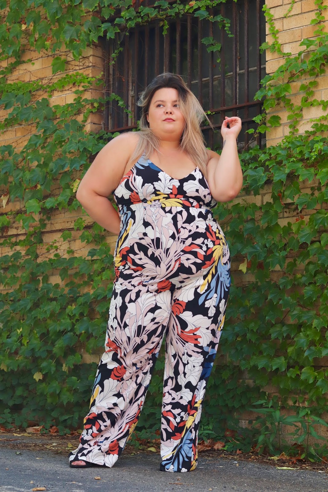 Chicago Plus Size Petite Fashion Blogger, influencer, YouTuber, and model Natalie Craig, of Natalie in the City, review's Fashion Nova's floral jumpsuits.