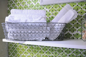 Terry Towels rolled up in a bread basket | OrganizingMadeFun.com
