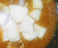 Adding potato (aloo) cubes with chicken to make Bengali chicken curry recipe