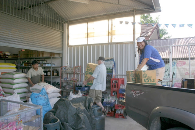 First we all pitch in to help unload Mr. Amnuay's  truck filled with supplies for his Gas Station Store