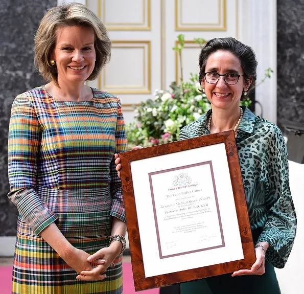 Professor Julie De Backer and professor Catherine Boileau. Queen Mathilde wore Emporio Armani multicolor dress. Natan multicolor dress