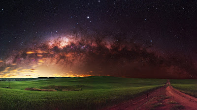 Galaxy HD wallpaper over green field