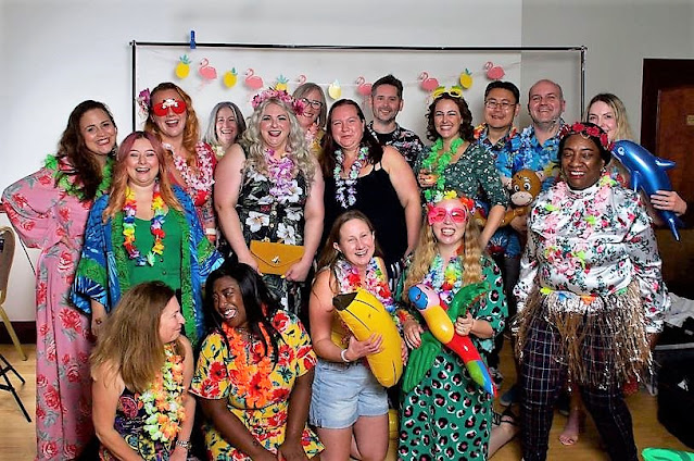 A group of 17 male and female bloggers all in beach themed party wear